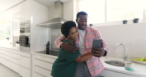 Happy Couple Taking Selfie in Modern Kitchen