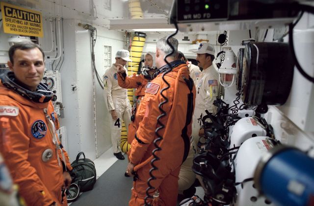 STS051-S-109 (12 Sept 1993) --- Inside the White Room, three astronaut crew members for the STS-51 flight await their queues to ingress the Space Shuttle Discovery.  Wearing the partial pressure launch and entry suits are, left to right, Carl E. Walz, mission specialist; Frank L. Culbertson Jr., mission commander; and William F. Readdy, pilot.  Not pictured are astronauts James H. Newman and Daniel W. Bursch.  Launch occurred at 7:45 a.m. (EDT), September 12, 1993.