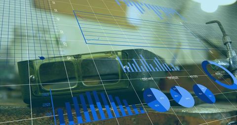 Resting welding goggles on worn metal workbench showing holographic blue charts and tools