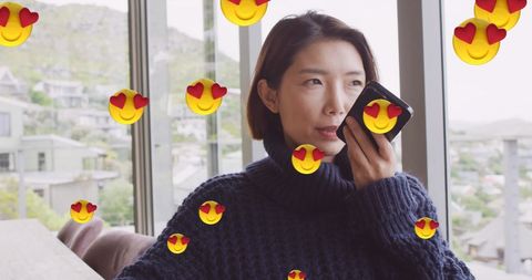 Asian Woman Using Smartphone with Love Emojis