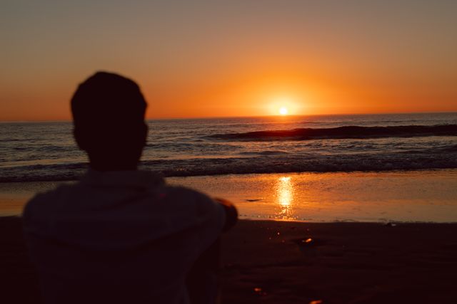 Man Watching Sunset on Beach - Download Free Stock Photos Pikwizard.com