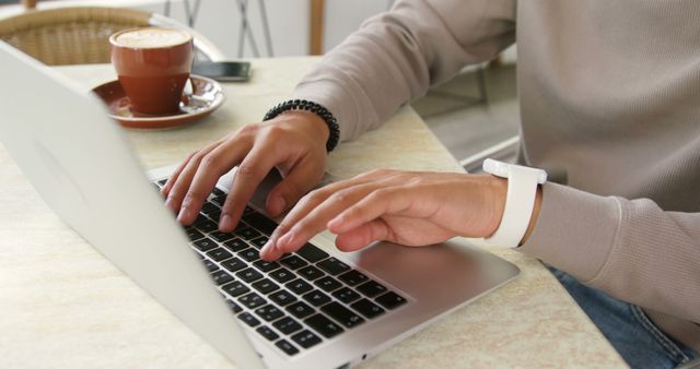 Person Typing on Laptop with Coffee Cup on Table in a Cafe - Download Free Stock Images Pikwizard.com