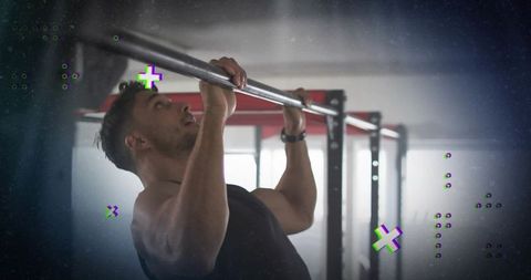 Athlete building strength with pull-up exercise in gym