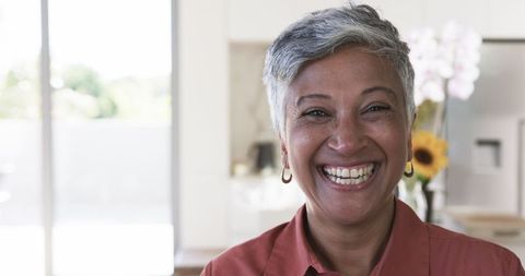 Joyful Mature Woman with Short Gray Hair in Home Setting