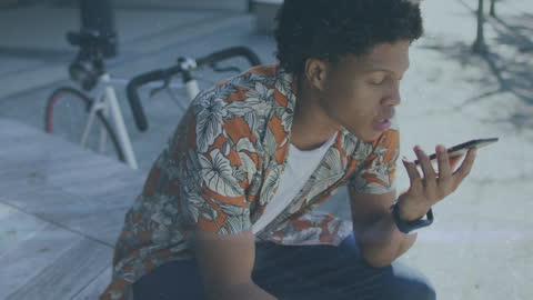 Young Man Using Voice Command on Smartphone Outdoors