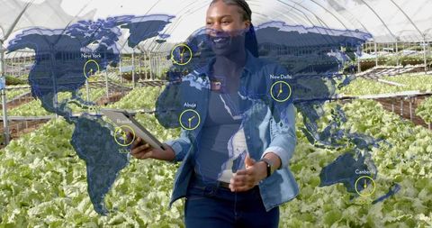 Agronomist with Tablet Showing Sustainable Greenhouse Innovation