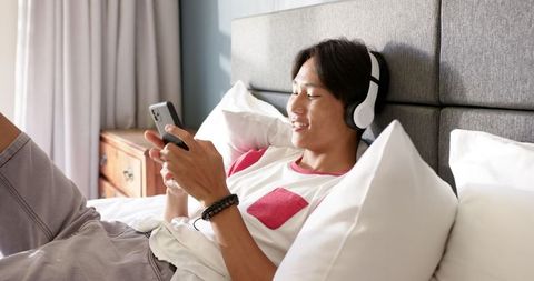 Teen Enjoying Relaxation with Smartphone and Headphones