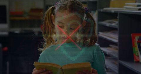 Caucasian schoolgirl reading book with digital interface overlay