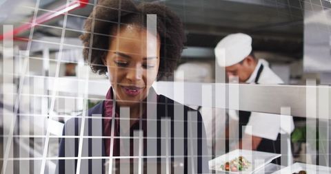 Businesswoman Analyzing Data in Modern Restaurant Kitchen