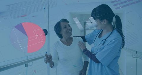 Nurse supporting patient through hospital corridor for recovery