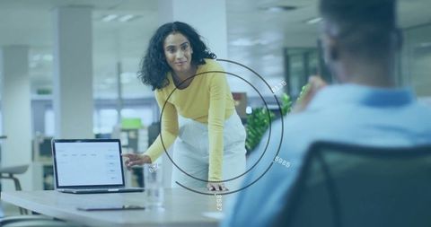 Focused Businesswoman Presenting Data to Colleague in Modern Office