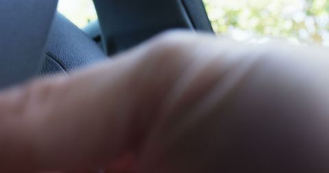 Abstract Close-Up of Blurred Hand in Car Interior