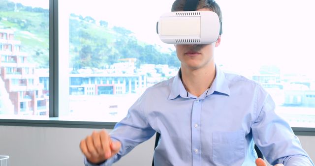 Man Experiencing Virtual Reality with VR Headset in Office - Download Free Stock Images Pikwizard.com