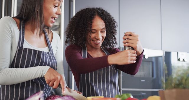 Two women preparing healthy meal together in modern kitchen - Download Free Stock Images Pikwizard.com