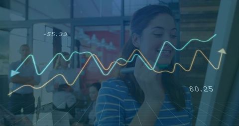 Businesswoman engaging with transparent digital data in modern office