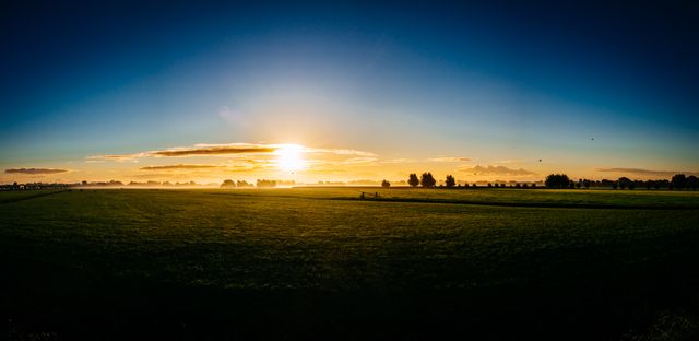 Panoramic View of Sunrise Over Lush Green Fields - Download Free Stock Photos Pikwizard.com
