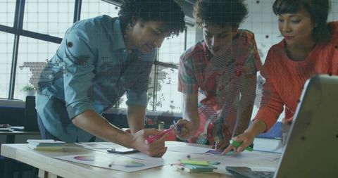 Diverse Team Analyzing Data in Modern Open Office