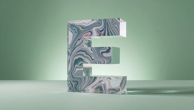 3d marbled letter e on pastel table for modern decor