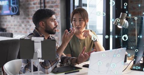 Business Professionals Discussing Digital Connections Technology in Modern Office