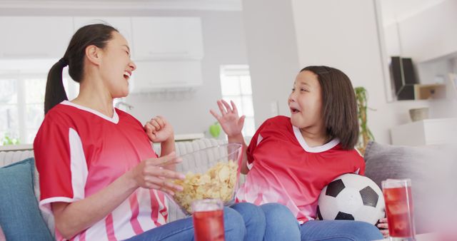 Mother and Daughter Watching Soccer Game at Home - Download Free Stock Images Pikwizard.com