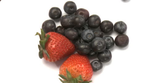 Fresh Juicy Strawberries and Blueberries on White Background