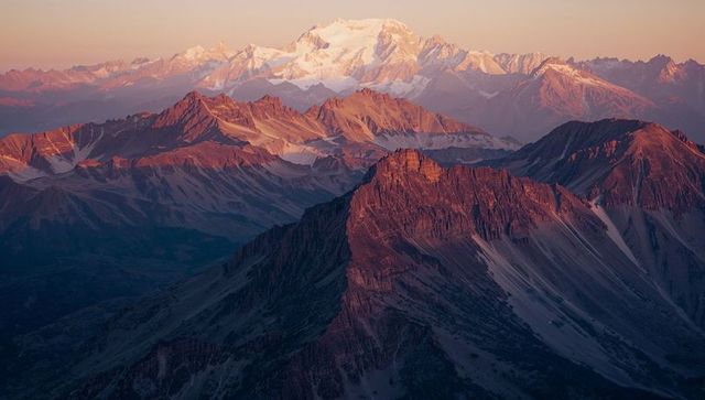 Majestic Mountain Range at Sunset with Glowing Peaks