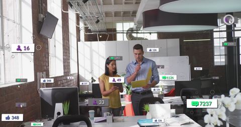 Coworkers Analyzing Data in Modern Office Setting