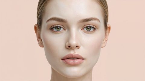 Elegant portrait of a beautiful lady with neutral makeup and peach background