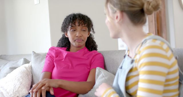 Two Women Having Serious Conversation on Couch at Home - Download Free Stock Images Pikwizard.com