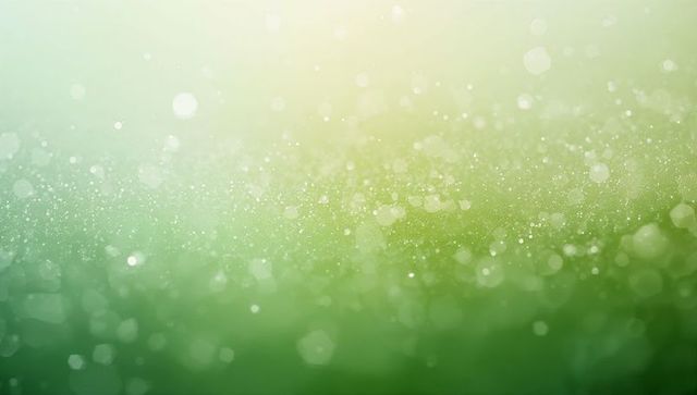 Shimmering green bokeh background with floating light particles and soft gradient