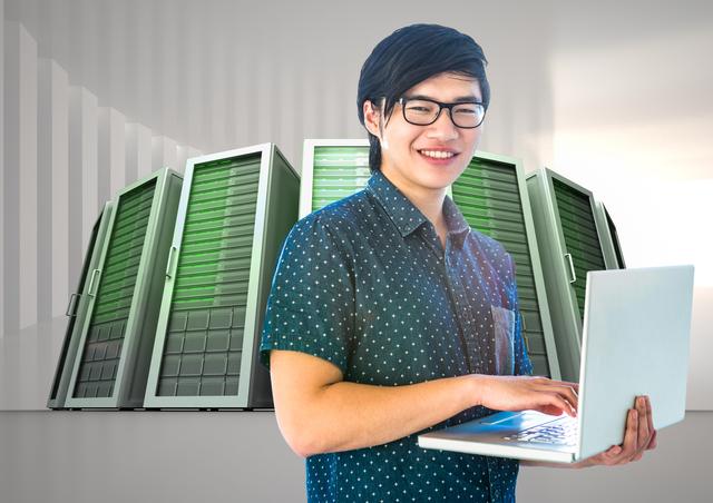 Depicts an IT professional smiling while using a laptop in a data center room with server towers in the background. Suitable for illustrating themes related to technology services, IT infrastructure, data management, cybersecurity, and cloud computing. Can be used for educational materials, tech-related articles, company blogs, and IT service promotions.