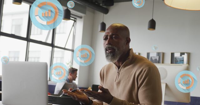 Older African American man analyzing data on laptop in modern office - Download Free Stock Images Pikwizard.com