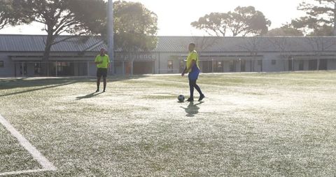 Sunny Soccer Practice with Players Preparing on Field