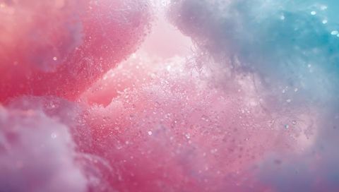 Glowing pastel cotton candy macro showing sparkling sugar crystals and soft bokeh