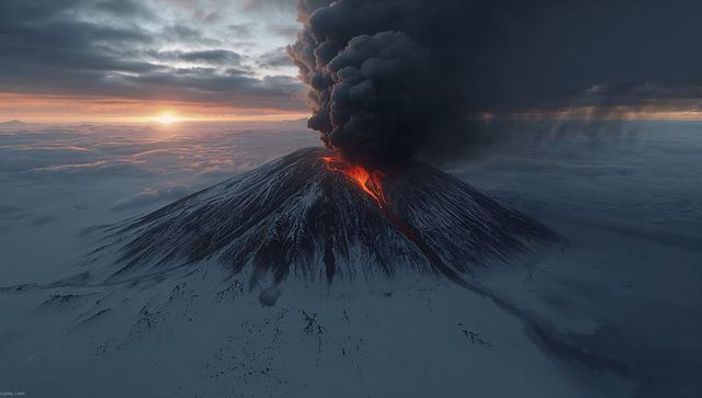 Majestic Volcano Eruption at Sunset Over Snowy Landscape