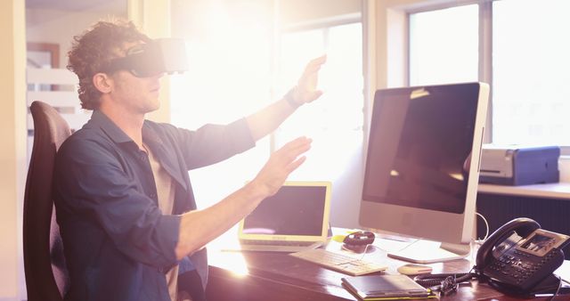 Man Interacting with Virtual Reality Technology at Office Desk - Download Free Stock Images Pikwizard.com