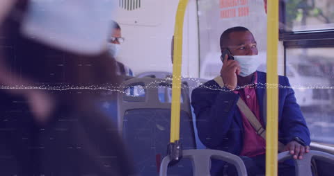 Commuters on Bus Wearing Masks Amid Digital Financial Data Overlay