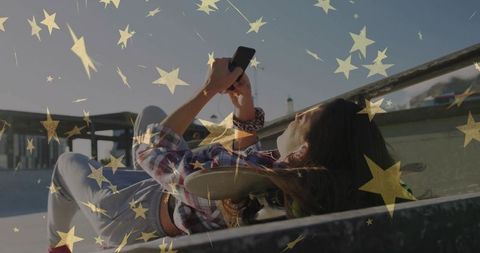 Young Woman Relaxing at Skate Park Using Smartphone, Refreshing Urban Break