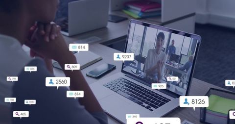 Watching virtual meeting on laptop with social notifications and collaboration overlays