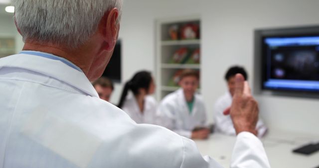 Senior Doctor Leading Training Session with Diverse Medical Team - Download Free Stock Images Pikwizard.com