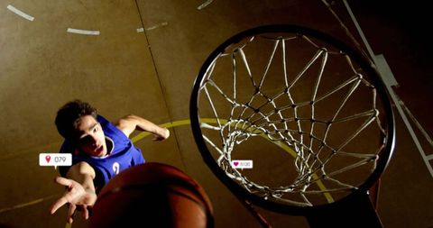 Leaping basketball player reaching for dunk with social media overlays and rim close-up