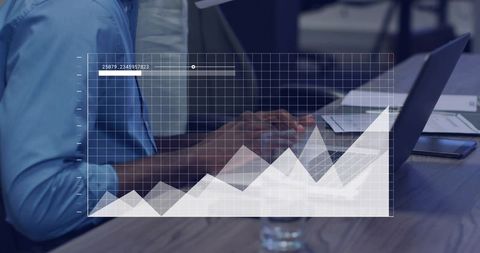 Business analytics overlay showing rising financial chart over office desk with laptop