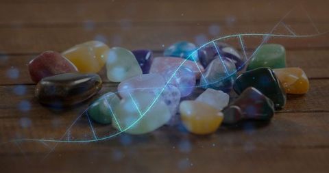 Polished Gemstones and Glowing DNA Helix Overlay on Wooden Table
