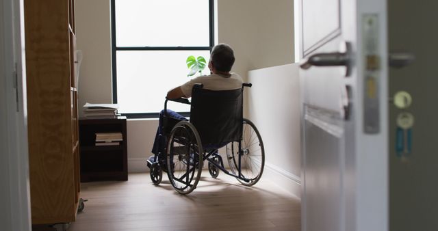 Elderly Male in Wheelchair Looking Out Window in Room - Download Free Stock Images Pikwizard.com