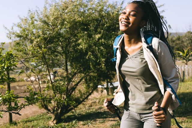 African American Woman Hiking with Sticks on Sunny Day - Download Free Stock Images Pikwizard.com