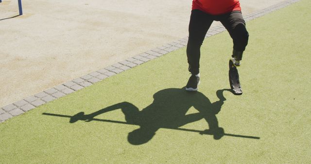 Biracial man exercising and lifting weight bar with prosthetic leg - Download Free Stock Photos Pikwizard.com