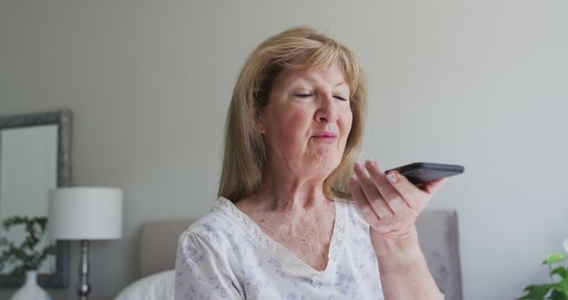 Senior woman using voice command on smartphone indoor - Download Free Stock Images Pikwizard.com