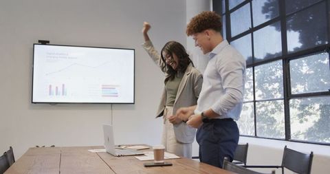 Successful Business Colleagues Celebrating Achievements in Meeting Room