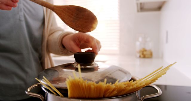 Preparing Dinner at Home with Pot of Boiling Spaghetti - Download Free Stock Images Pikwizard.com