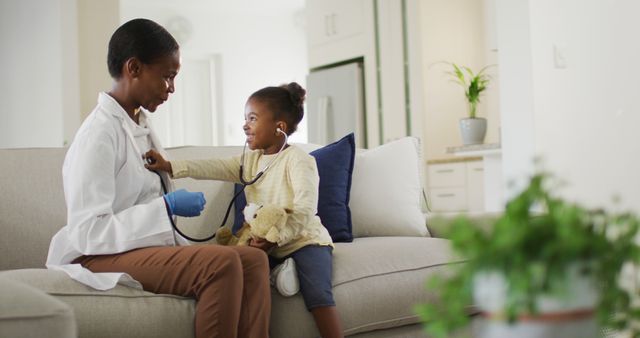 Female Pediatrician Examining Child in Living Room - Download Free Stock Images Pikwizard.com